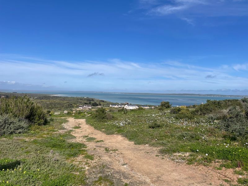 A scenic view of the coastal landscape and surrounding residential area from the vacant residential plot.
