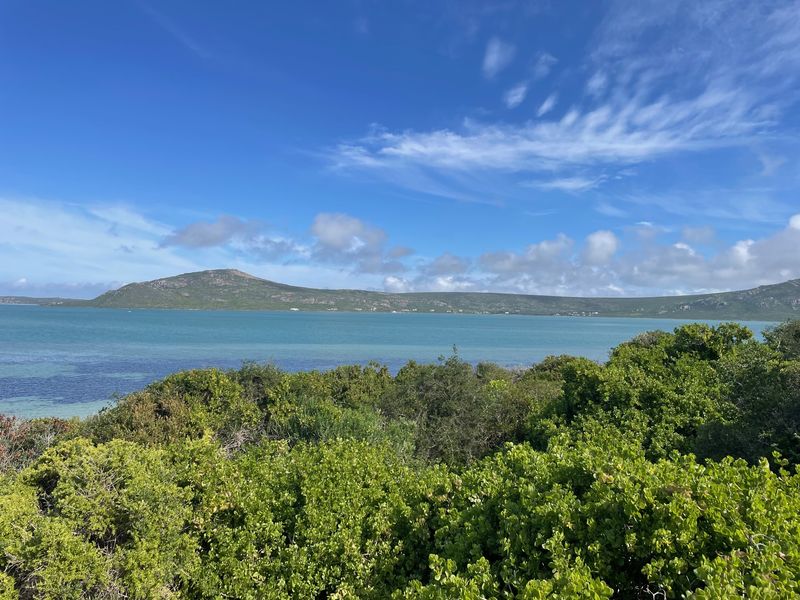 A scenic view overlooking the lagoon and surrounding hills, showcasing the natural landscape and coastal beauty of the vacant residential land.