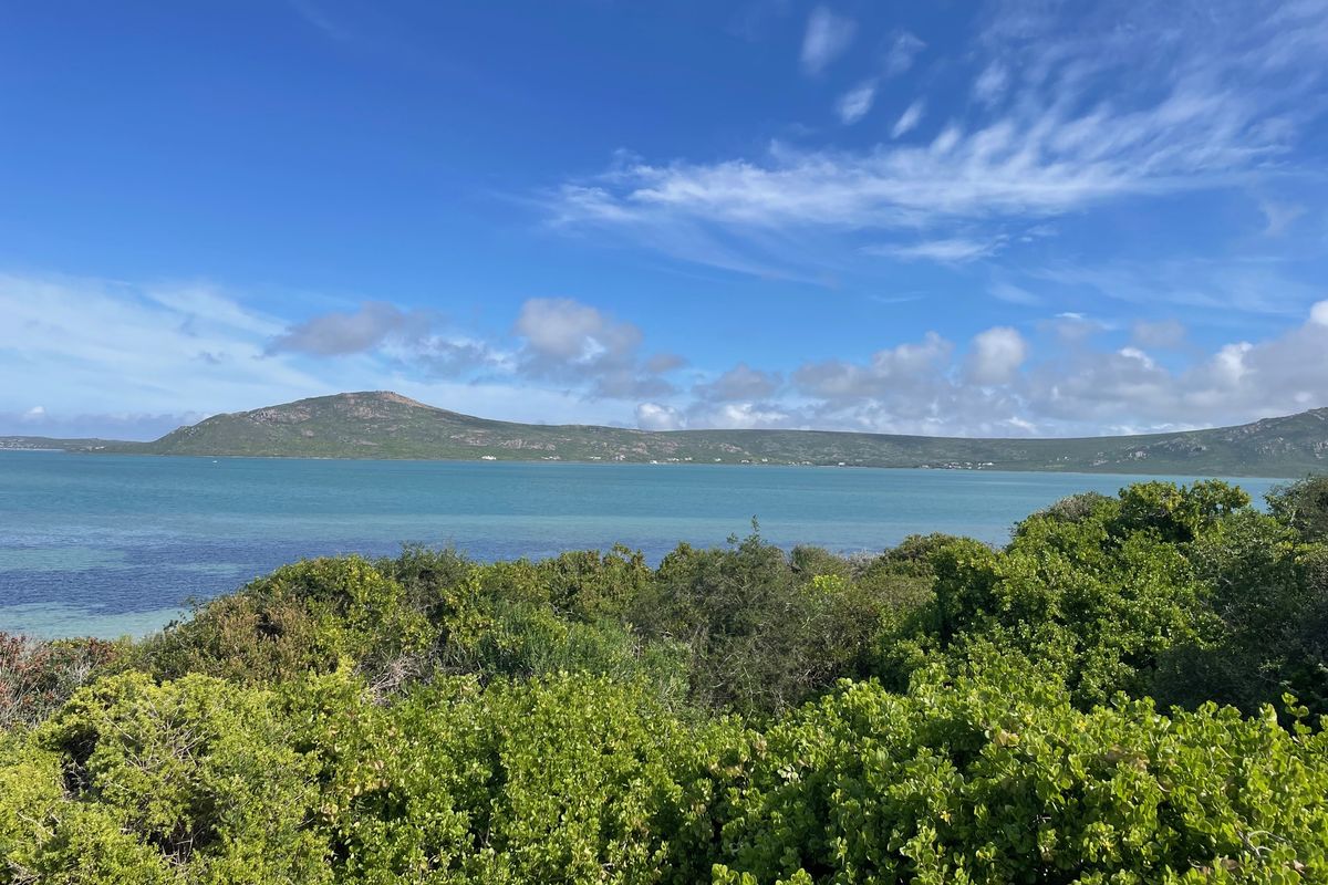 A scenic view overlooking the lagoon and surrounding hills, showcasing the natural landscape and coastal beauty of the vacant residential land.