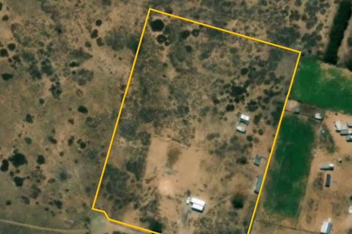 Aerial view of the small holding property showing the fenced boundary and existing structures on the land.