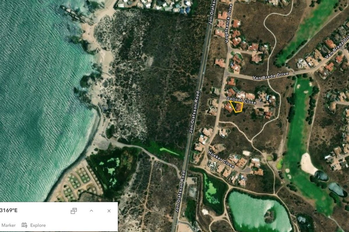 An aerial satellite view showing the property location in relation to the coastline, local roads, and surrounding residential area.