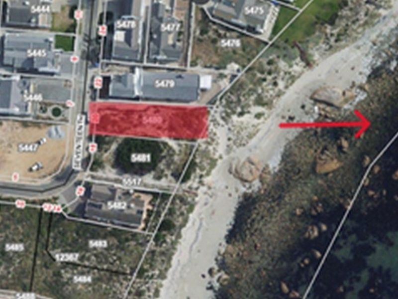 An aerial view of a vacant residential land parcel situated in a coastal location with direct proximity to the beach.