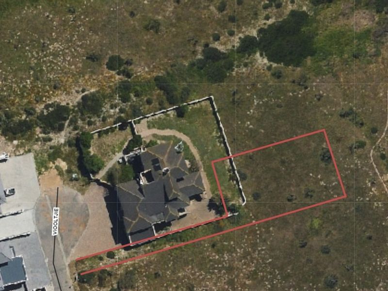 Aerial view of a residential vacant land plot with boundary lines indicated, situated in a coastal or semi-rural development.