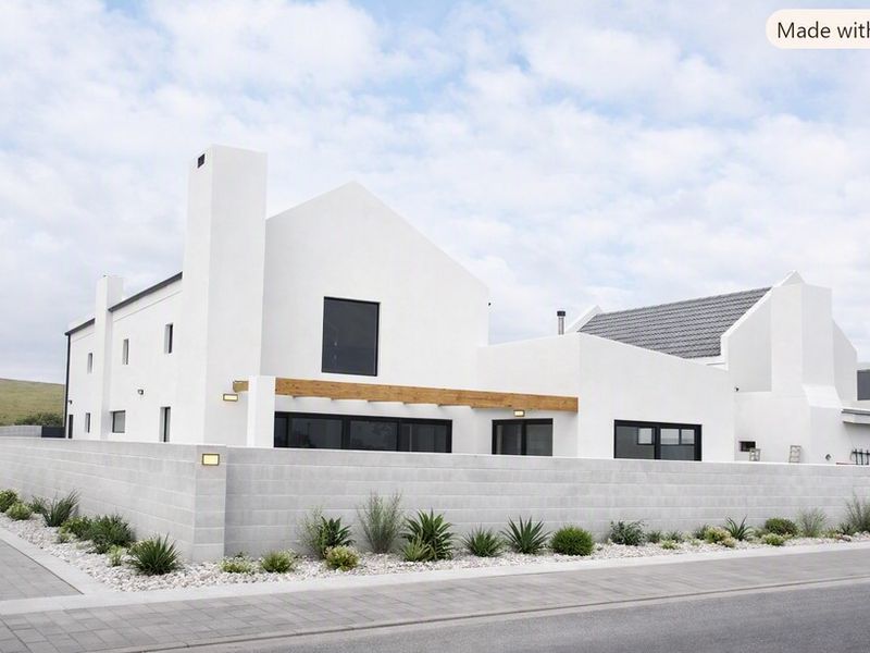 Modern white architectural home featuring a clean facade, timber pergola, and a secure concrete block boundary wall.