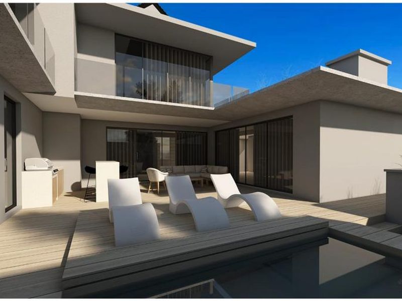 Modern outdoor entertainment area featuring a swimming pool, timber decking, and a built-in outdoor kitchen, seamlessly connected to the residence via sliding glass doors.