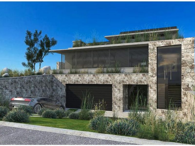 Modern architectural residence featuring natural stone cladding, a double garage, and integrated landscaping, presenting a contemporary aesthetic.