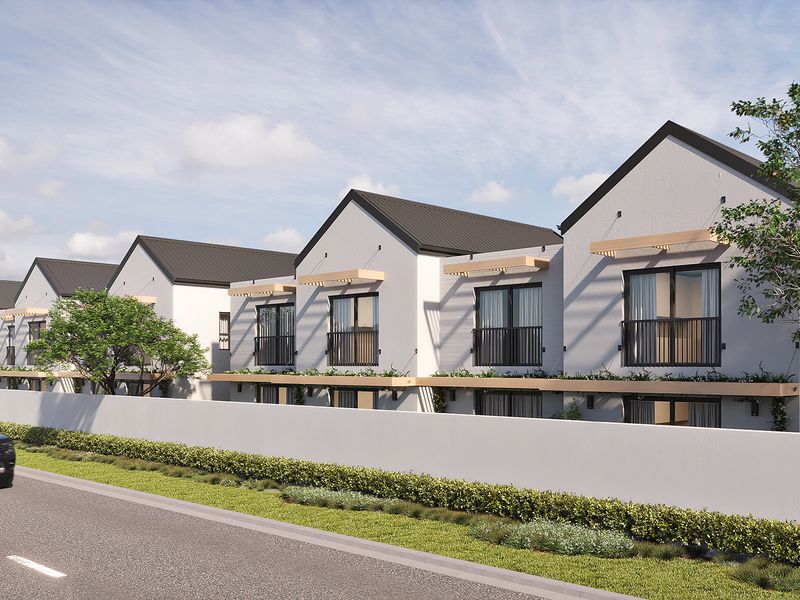 A modern townhouse development featuring pitched roofs, timber pergolas, and private balconies, viewed from the street.