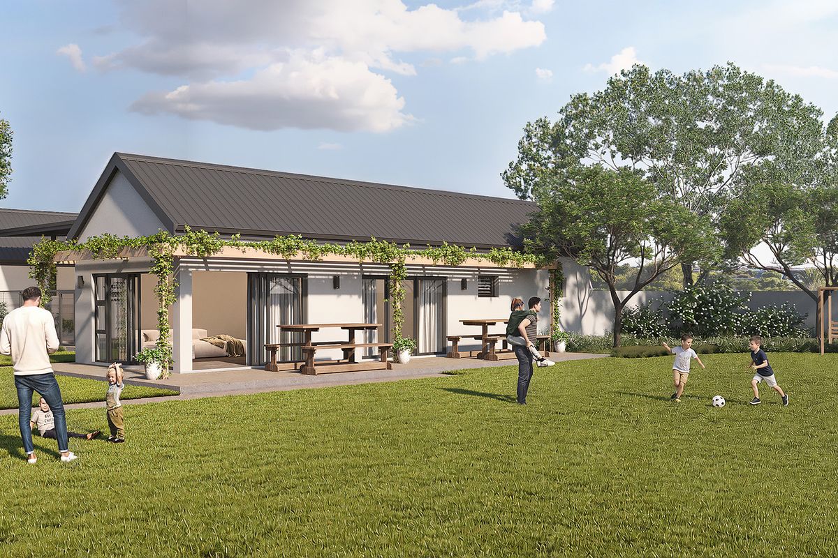 A spacious rear garden featuring a covered patio with a pergola and large sliding glass doors, perfect for outdoor living and entertaining.