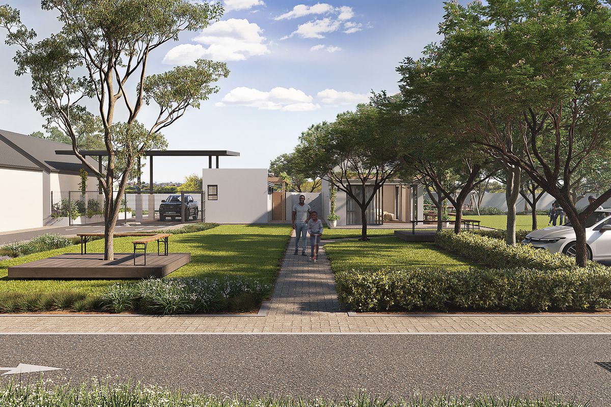 A modern townhouse complex exterior featuring a landscaped garden, paved walkways, and dedicated parking areas within a well-maintained residential estate.