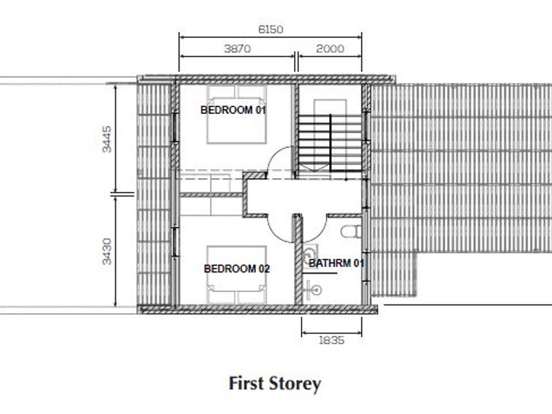 Architectural floor plan of the first storey showing the layout of two bedrooms, a bathroom, and a staircase.