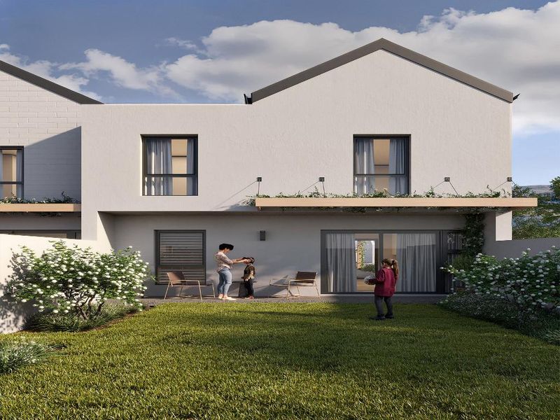 Rear view of a modern townhouse featuring a private garden, a ground-floor patio with sliding glass doors, and an upper-level balcony.