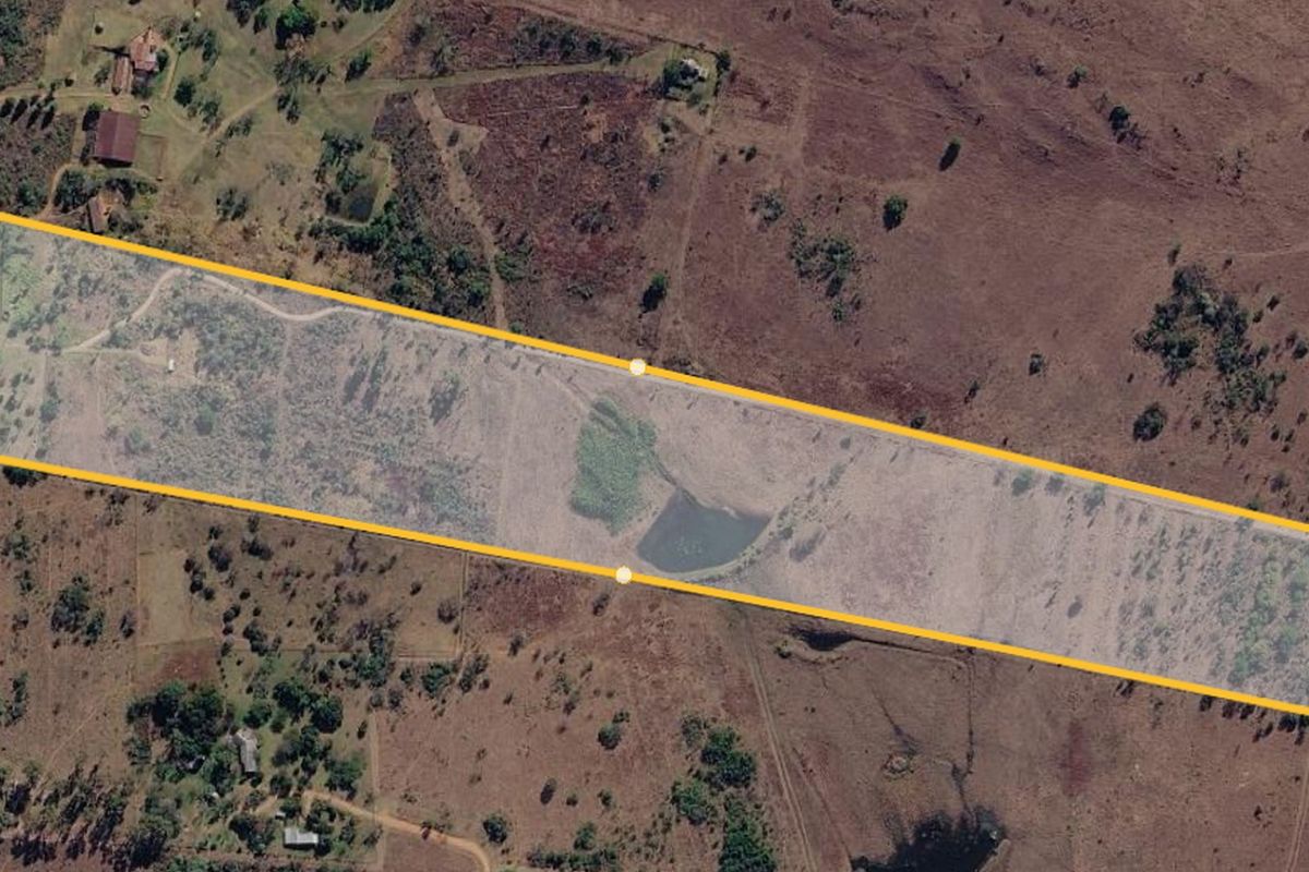 Aerial view of the farm property highlighting the land boundaries, including a small dam and natural landscape features.
