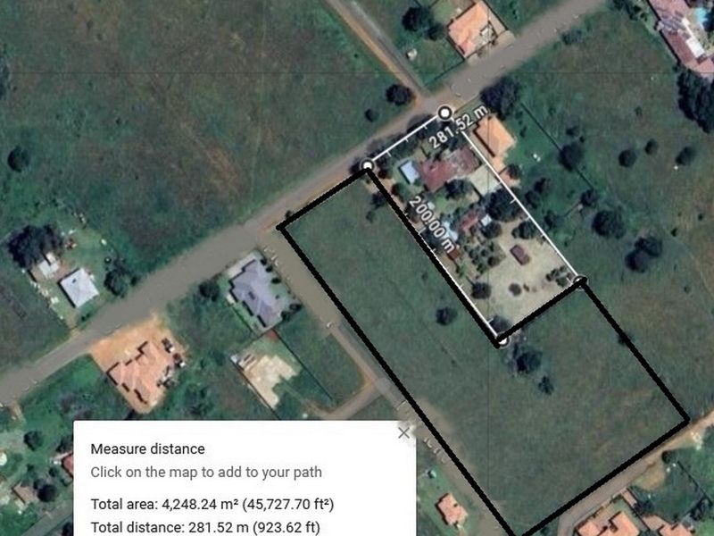 An aerial satellite view showing the boundary lines and measurements of a residential vacant land plot.