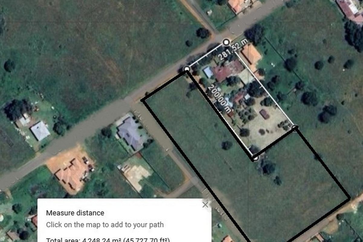 An aerial satellite view showing the boundary lines and measurements of a residential vacant land plot.