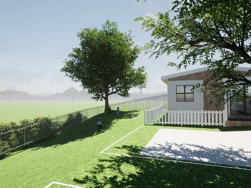 A modern residential exterior featuring a brick facade, paved driveway, and secure perimeter fencing set against a scenic mountain backdrop.
