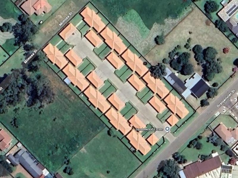 Aerial view of Sandalwood Estate townhouse complex showing the layout of units, roof structures, and internal driveway access.
