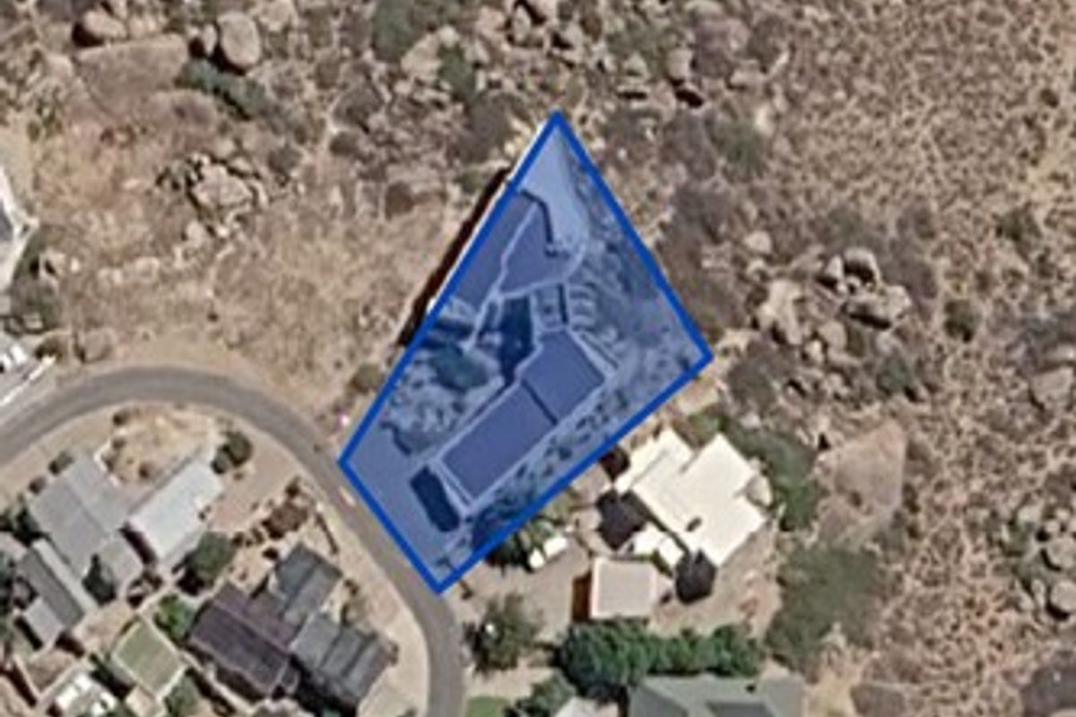 An aerial satellite view showing the property boundary and surrounding residential landscape.