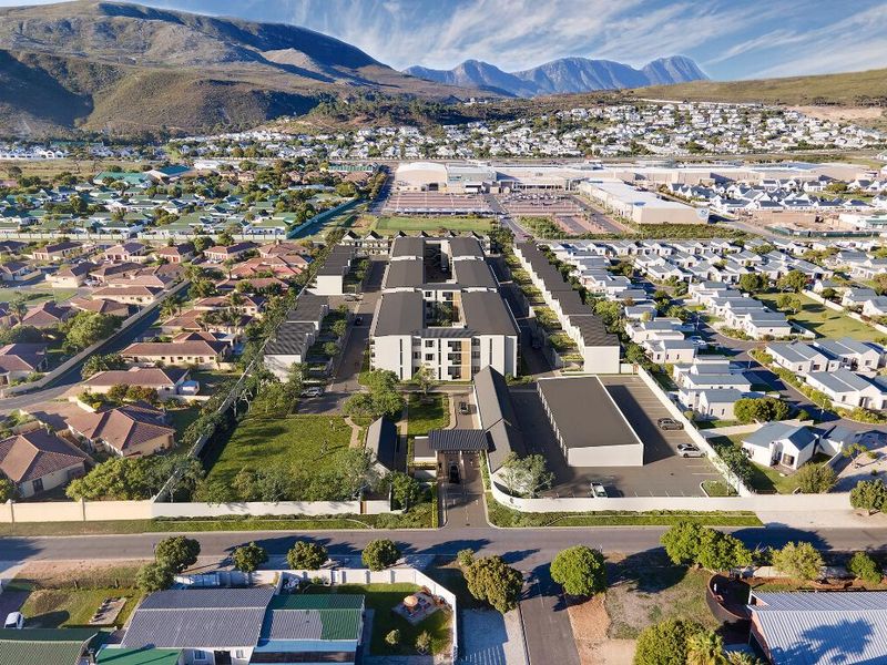 Aerial view of a modern apartment complex featuring landscaped grounds, secure gated access, and dedicated parking areas within a residential neighborhood.