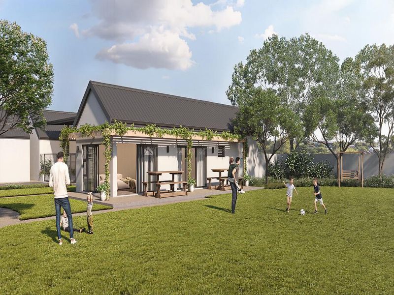 A rear view of a modern apartment unit featuring a covered patio with a pergola, sliding glass doors, and access to a private garden area.