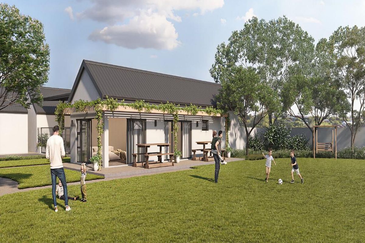A rear view of a modern apartment unit featuring a covered patio with a pergola, sliding glass doors, and access to a private garden area.