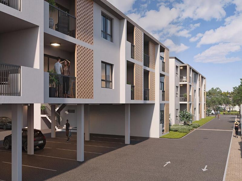 Modern apartment complex featuring covered ground-level parking, private balconies with decorative brick screening, and well-maintained exterior finishes.