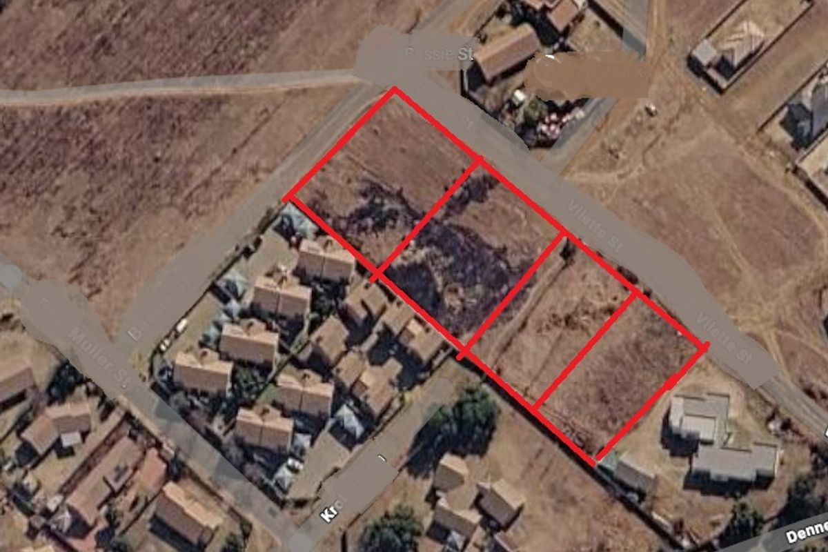 An aerial view showing multiple vacant residential plots of land with street access in a developing suburban area.