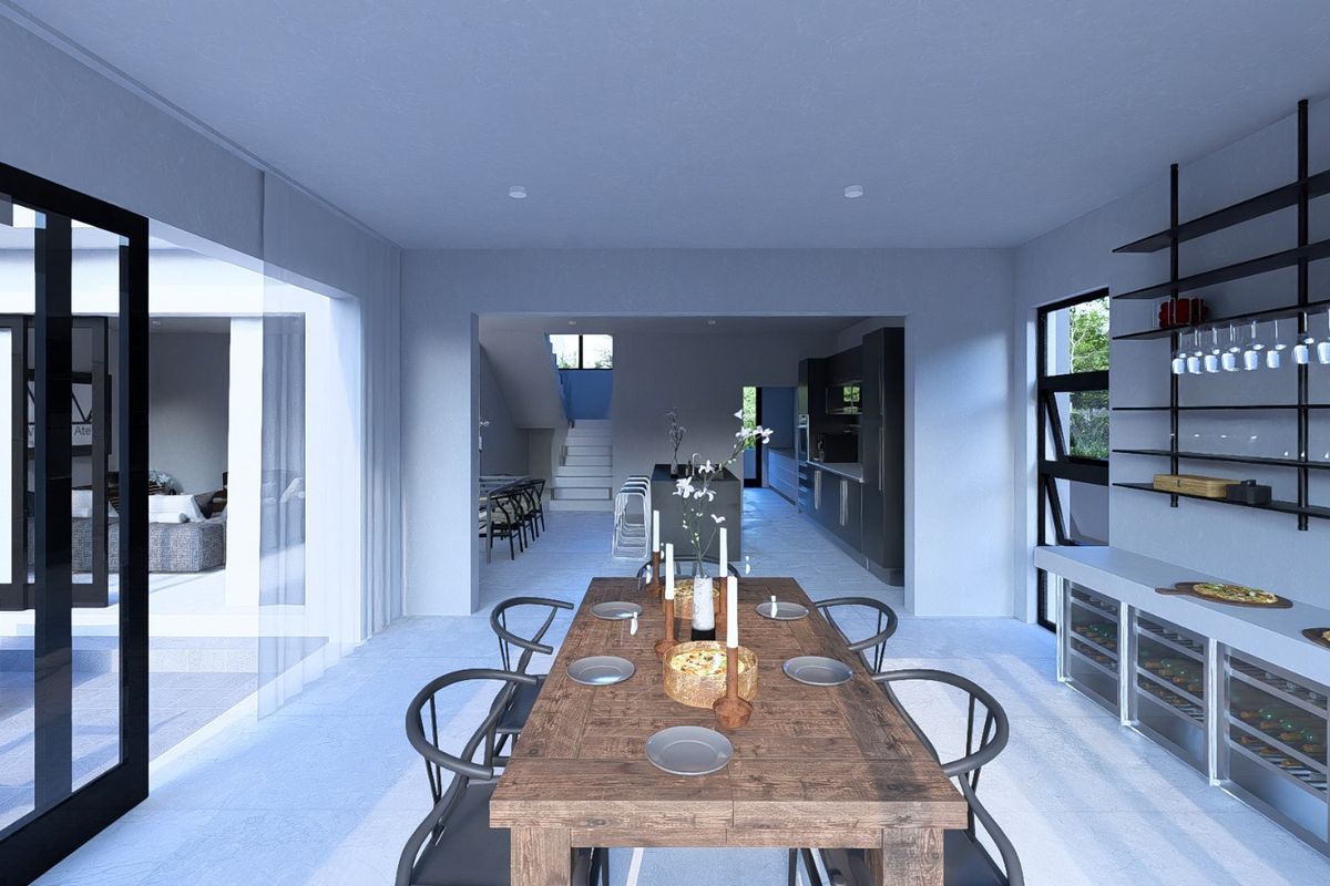Modern open-plan living and dining area featuring a sleek kitchen island, built-in wine storage, and seamless access to the outdoor patio through sliding doors.