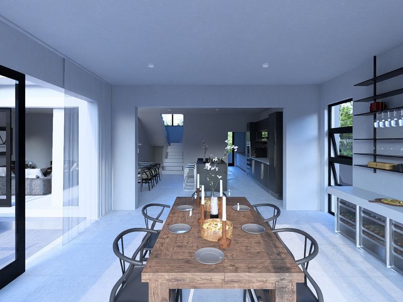 Modern open-plan living and dining area featuring a sleek kitchen island, built-in wine storage, and seamless access to the outdoor patio through sliding doors.