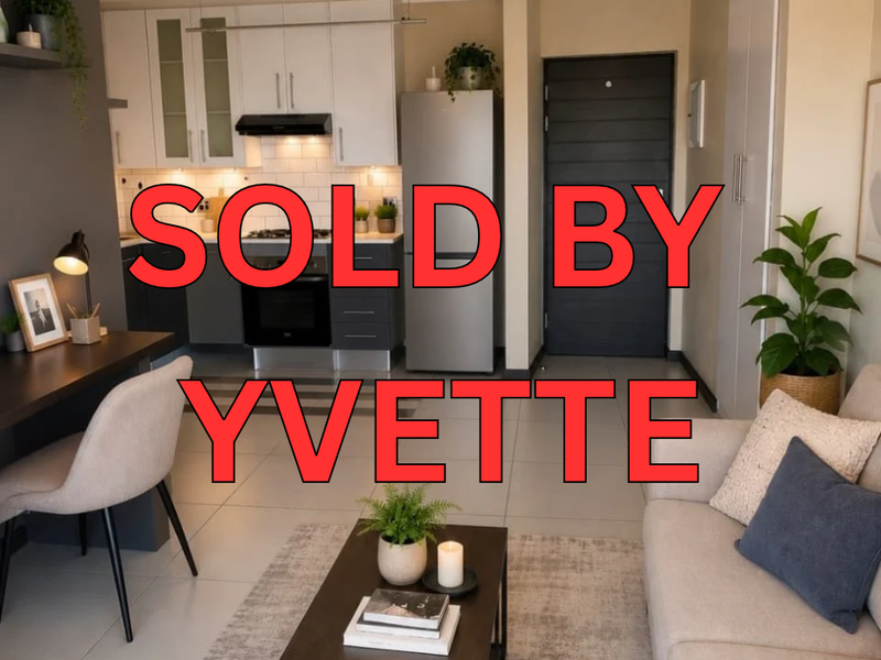 Open plan living area featuring a modern kitchen with built-in cabinetry, integrated appliances, and tiled flooring throughout.