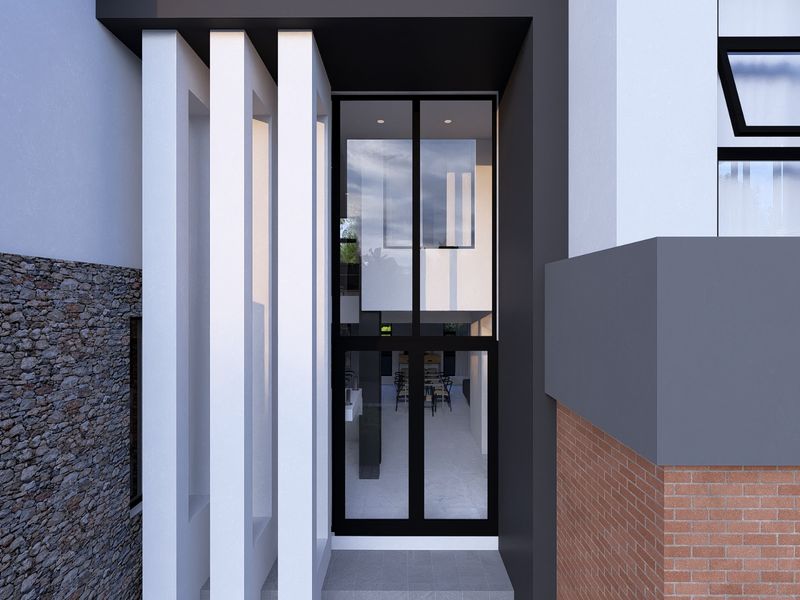 Modern entrance featuring a striking combination of stone cladding, brickwork, and architectural pillars leading to a glass-paneled front door.