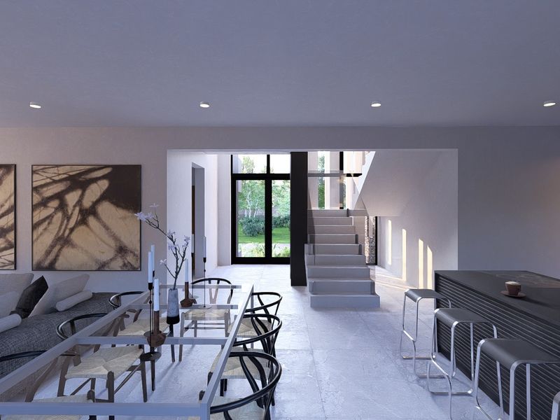Modern open-plan living and dining area featuring a sleek kitchen island, stone flooring, and a central staircase leading to the upper level.