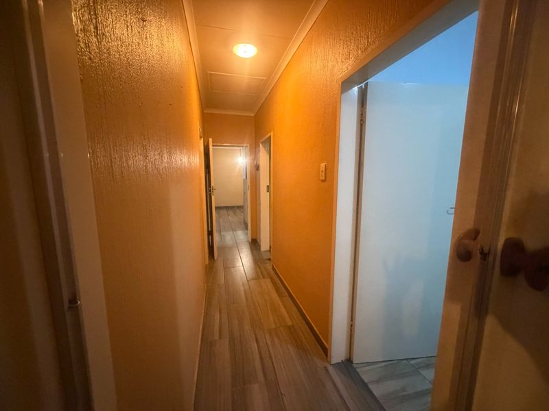 A functional hallway featuring tiled flooring and access to multiple rooms, providing a central circulation space within the home.