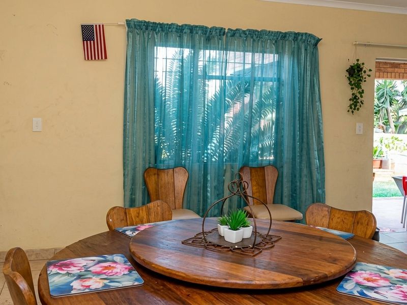 Dining area featuring tiled flooring and a sliding glass door providing access to the outdoor patio space.