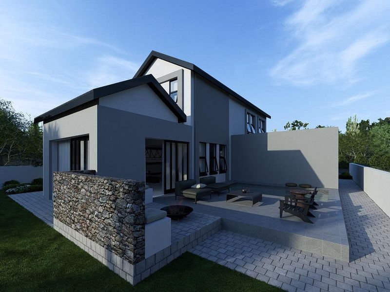 Rear view of a modern house featuring a tiled patio, stone-clad feature wall, and sliding glass doors leading to the interior.