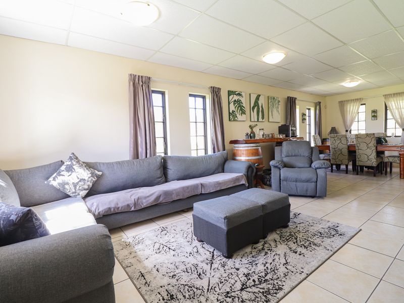 Spacious open-plan living and dining area featuring tiled flooring and a drop ceiling, providing a versatile layout for family living and entertaining.
