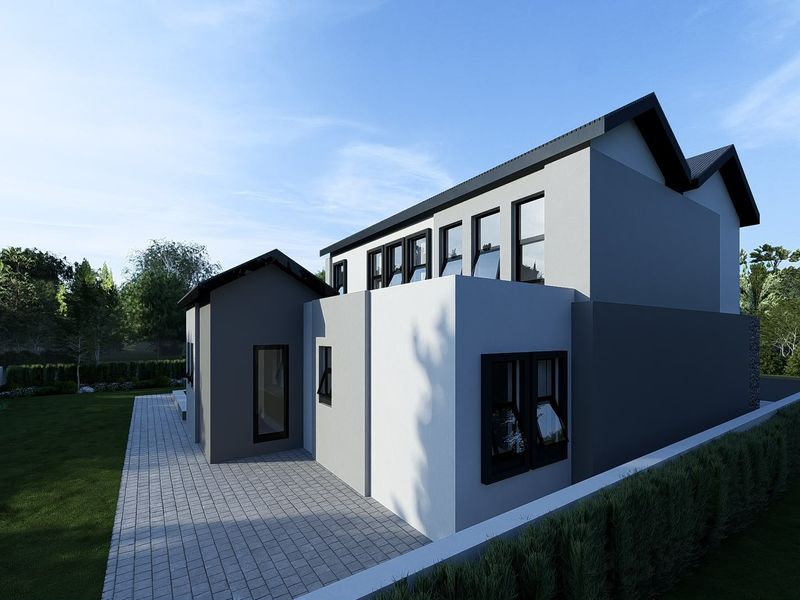 A modern rear exterior view of the house featuring a paved patio area, clean architectural lines, and a well-maintained garden.