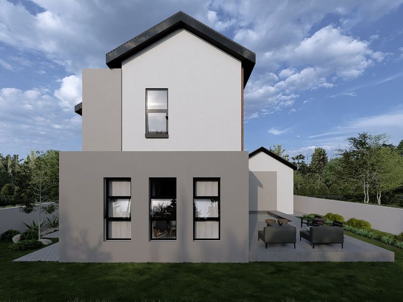 Rear view of a modern two-story house featuring a paved patio area, clean architectural lines, and a well-maintained garden.
