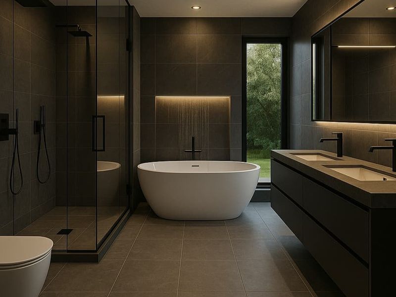 Modern luxury bathroom featuring a freestanding bathtub, walk-in shower, double vanity, and sleek dark tiling with ambient lighting.
