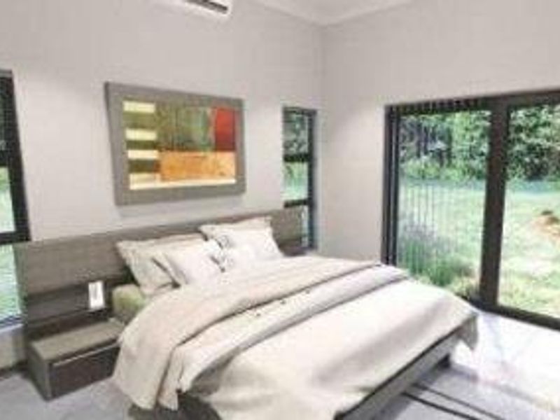 A modern bedroom featuring tiled floors, split-system air conditioning, and large sliding glass doors providing direct access to the garden area.