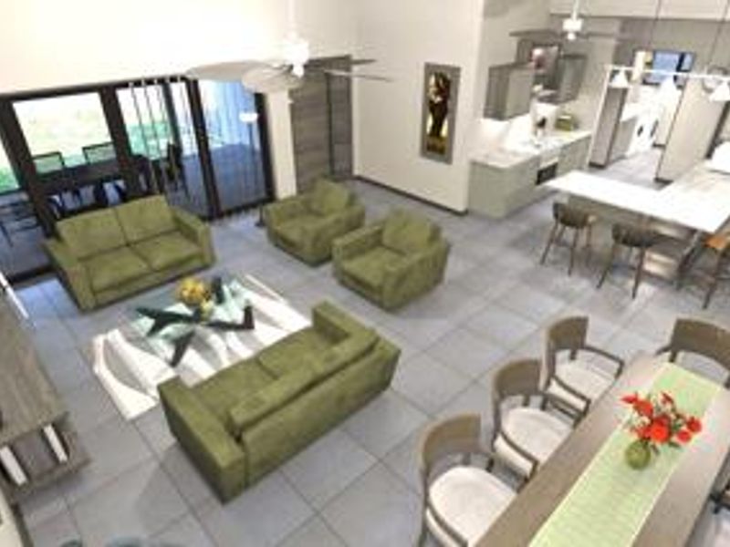 Spacious open-plan living area featuring a modern kitchen with island, dining space, and large sliding doors leading to an outdoor patio.