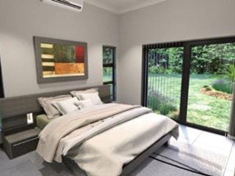Modern bedroom featuring tiled flooring, a built-in headboard, split-system air conditioning, and large sliding glass doors providing direct access to the garden.