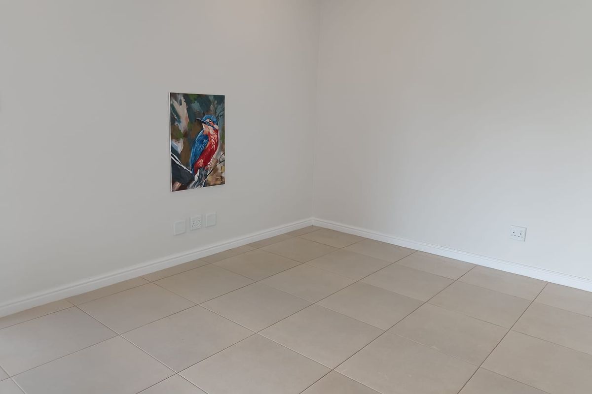 A clean, empty room featuring neutral tiled flooring and white walls, providing a versatile blank canvas for any living space or bedroom.