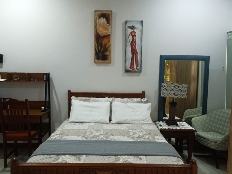 A standard bedroom featuring neutral wall finishes and space for a double bed.