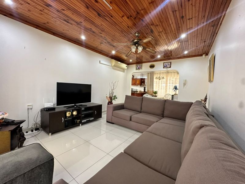Open plan living area featuring timber tongue and groove ceilings, recessed lighting, ceiling fan, split system air conditioning, and large format floor tiles.