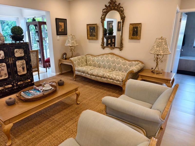 A well-maintained living room featuring neutral tiled flooring and a spacious layout, providing a comfortable and inviting atmosphere for relaxation.