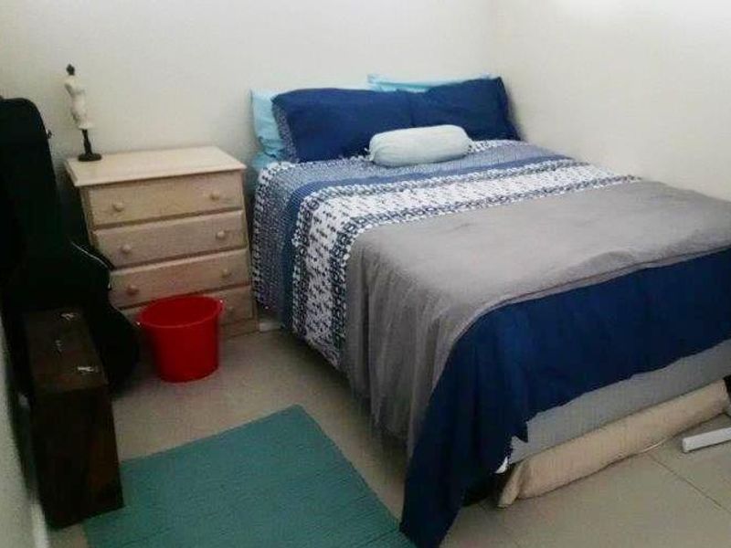 A compact bedroom featuring tiled flooring and neutral wall finishes, suitable for a single or double bed configuration.