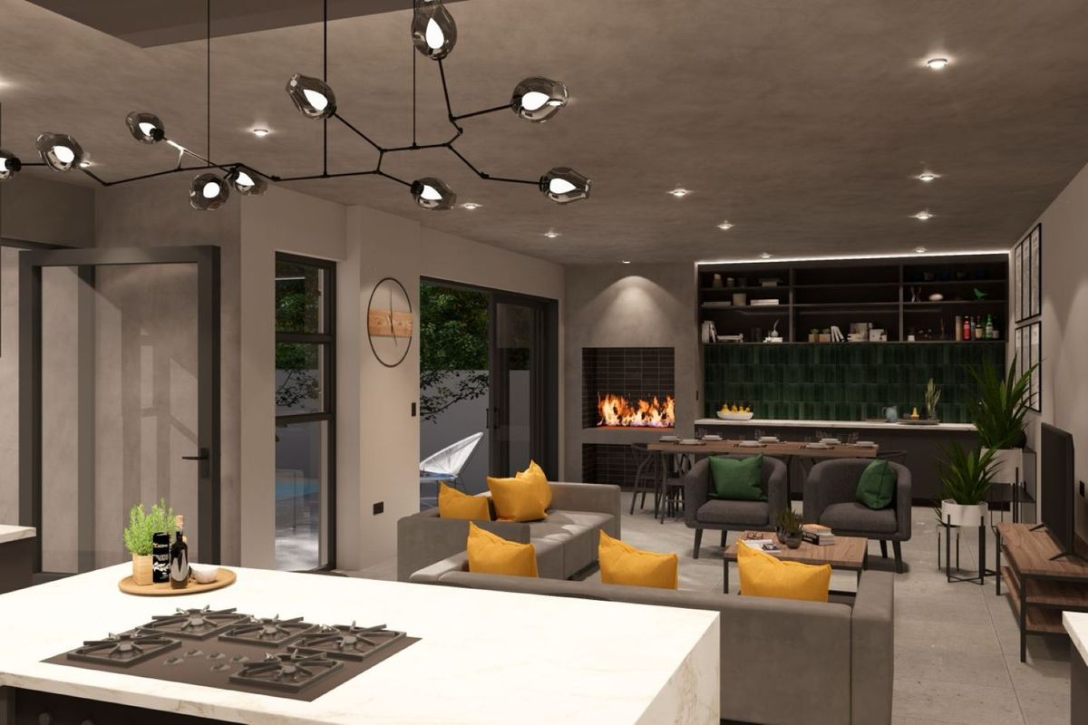Modern open-plan living area featuring a central kitchen island with gas hob, built-in fireplace, and seamless flow to the outdoor patio area.