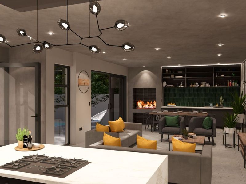 Modern open-plan living area featuring a central kitchen island with gas hob, built-in fireplace, and seamless flow to the outdoor patio area.