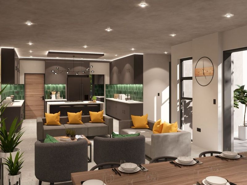 Modern open-plan living area featuring a contemporary kitchen with island, sleek cabinetry, and seamless flow to the outdoor patio through large sliding glass doors.