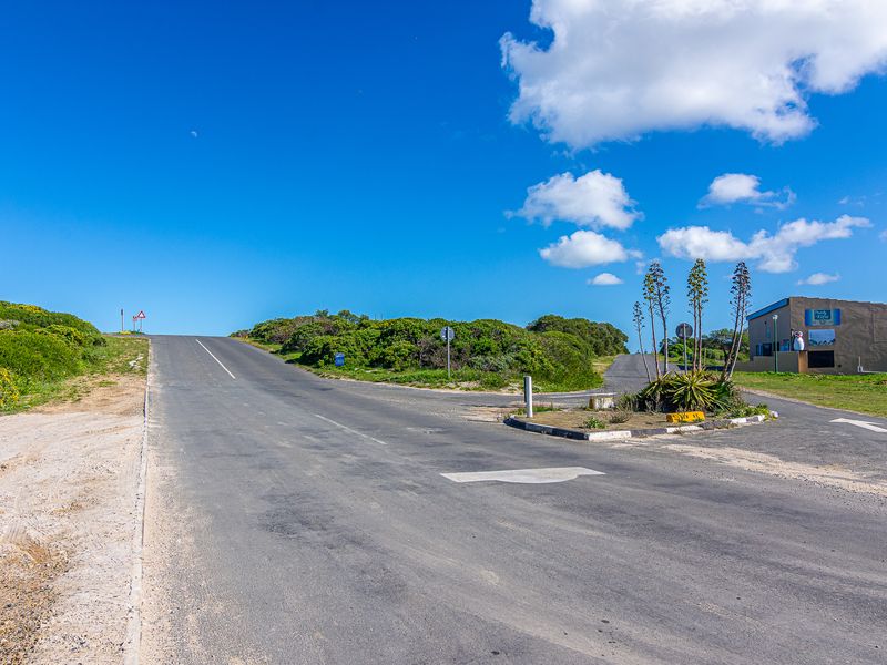 A view of the local street infrastructure and surrounding landscape, showing road access and nearby vegetation.
